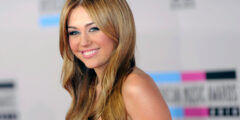Miley Cyrus smiling because she's rich